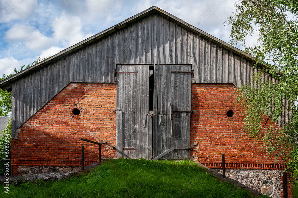 Abandoned Barn. Weathered and worn red barn on an abandoned farm. Latvia. Abandoned Barn. Weathered and worn red barn on an abandoned farm. Latvia.