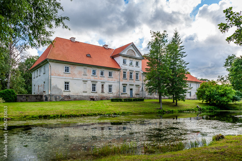 Back view of the Pope manor through the pond. Latvia, Baltic.