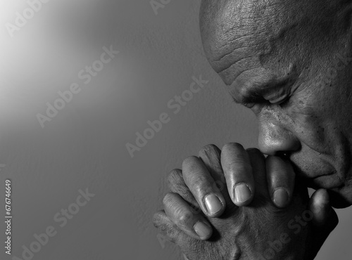praying to God with the bible on black background with people stock image stock photo © herlanzer