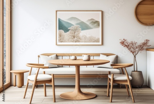 Round wooden dining table and rustic chairs with a sofa near the wall with an art frame.