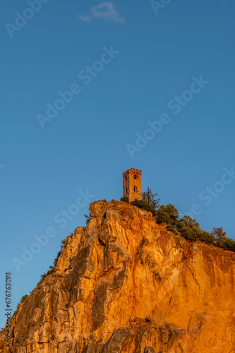 The ancient Upezzinghi Tower of Caprona, Pisa, Italy, illuminated by sunset light photo