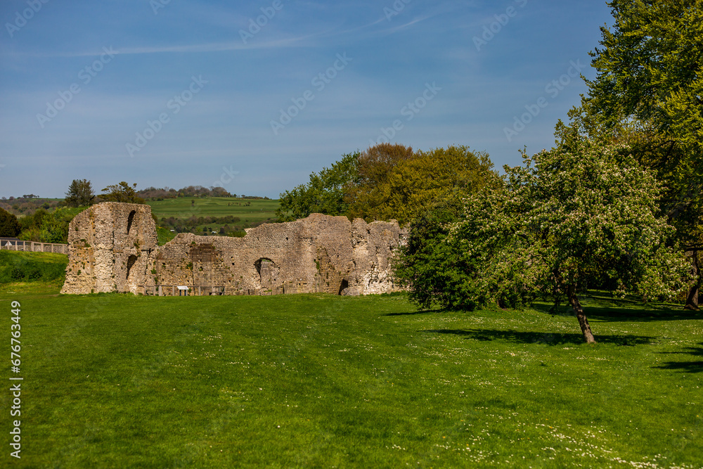 The ruins of Lewes Priory in Sussex, with a blue sky overhead