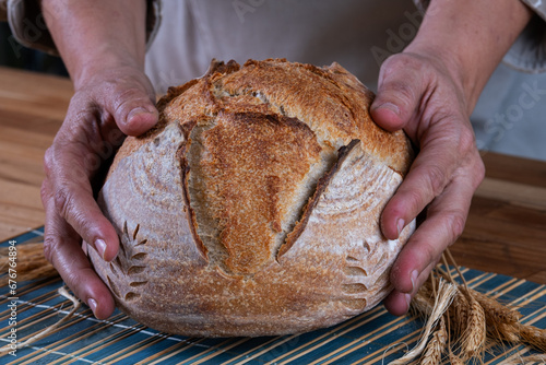 female hands holding natural fermentation artisanal bread