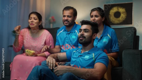 Group of family members celebrating team indias victory on cricket after eagerly waiting on tv or television - concept of world cup tournament, world cup tournament and intense sports
