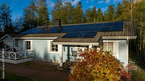 Quadro su tela Aerial view in front of a modern home powered by sustainable energy, sunny autum