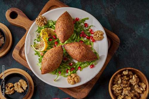 A plate of oriental fried kibbeh on a wooden floor photo