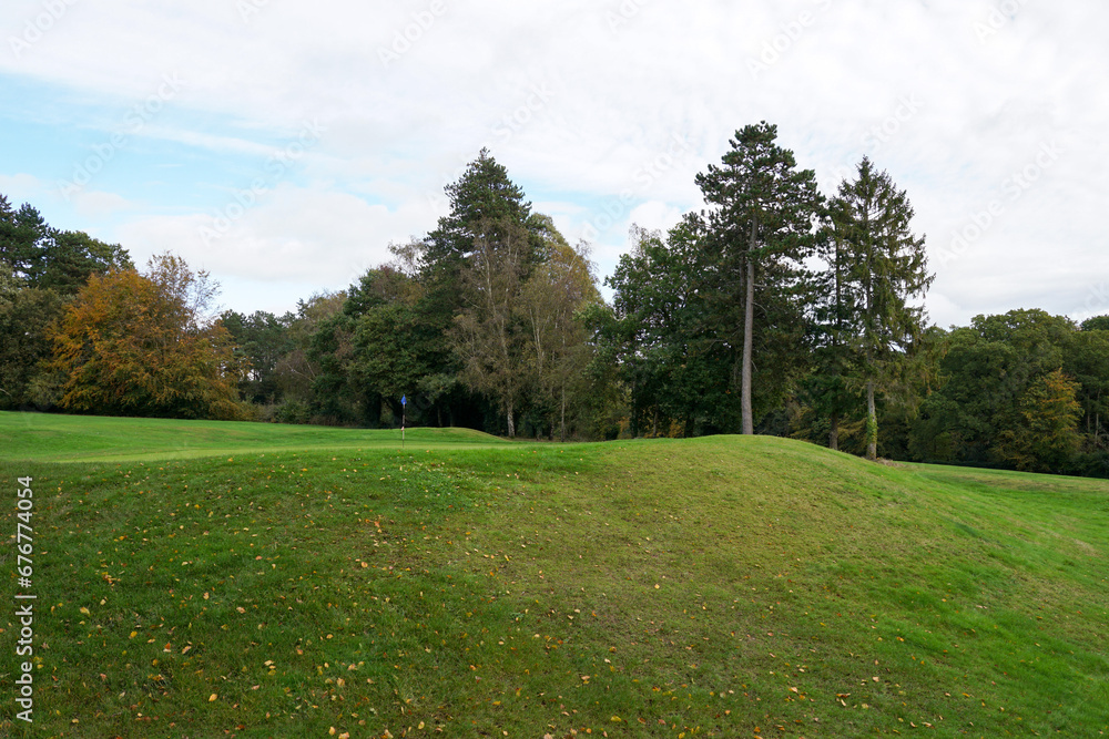 golf course landscape. putting green surrounded by trees on 18 hole golf course. sport and leisure 