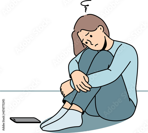 Sad woman is waiting for phone call, sitting on floor and suffering from loneliness or lack friends