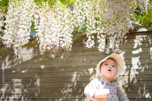 Baby girl in a flower garden in spring