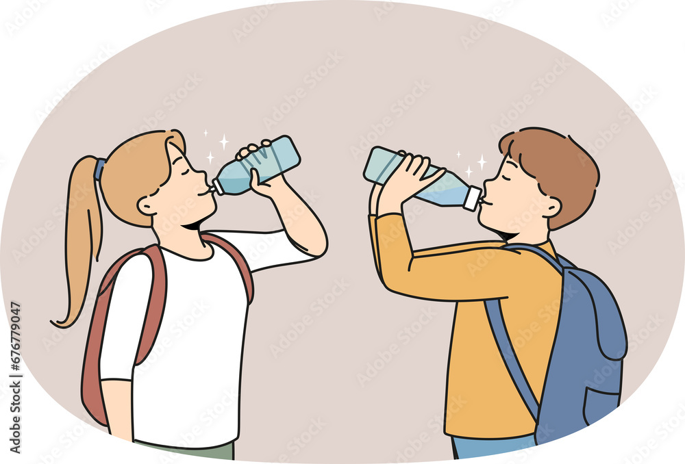 Children drinking fresh water from bottles Children drinking fresh water from bottles