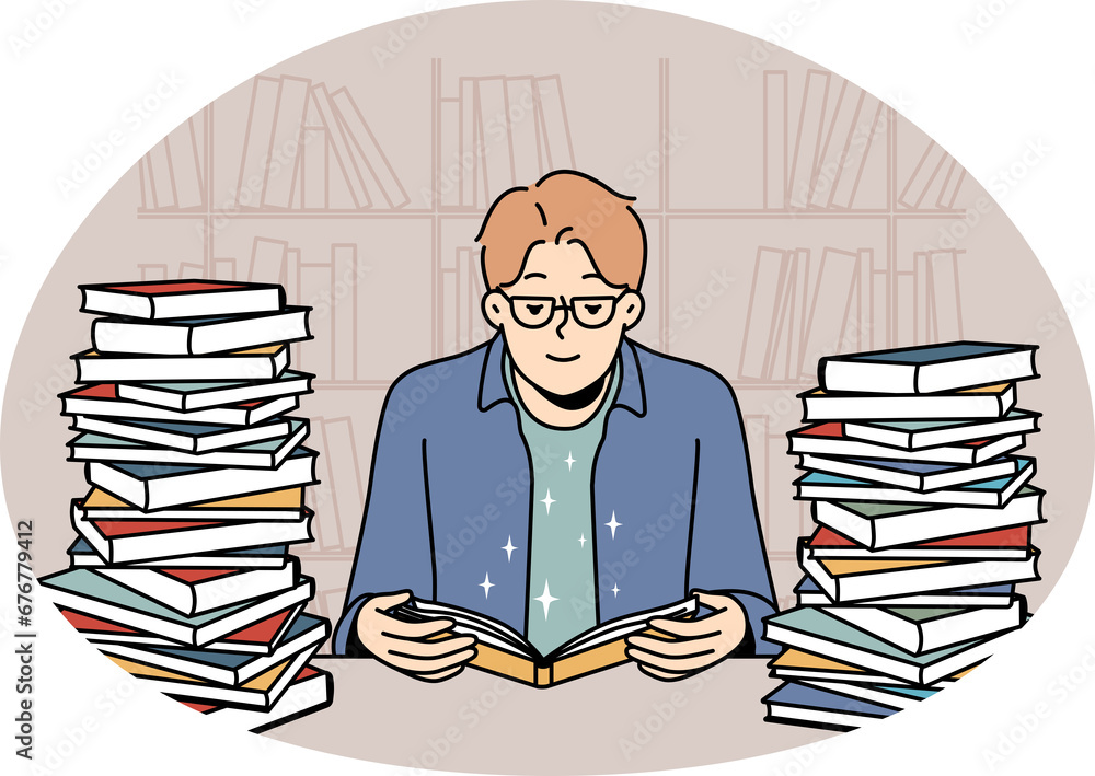 Young man with book pile reading and studying