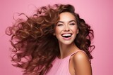 Portrait of positive emotion smiling beauty woman on studio lighting isolated pink background.