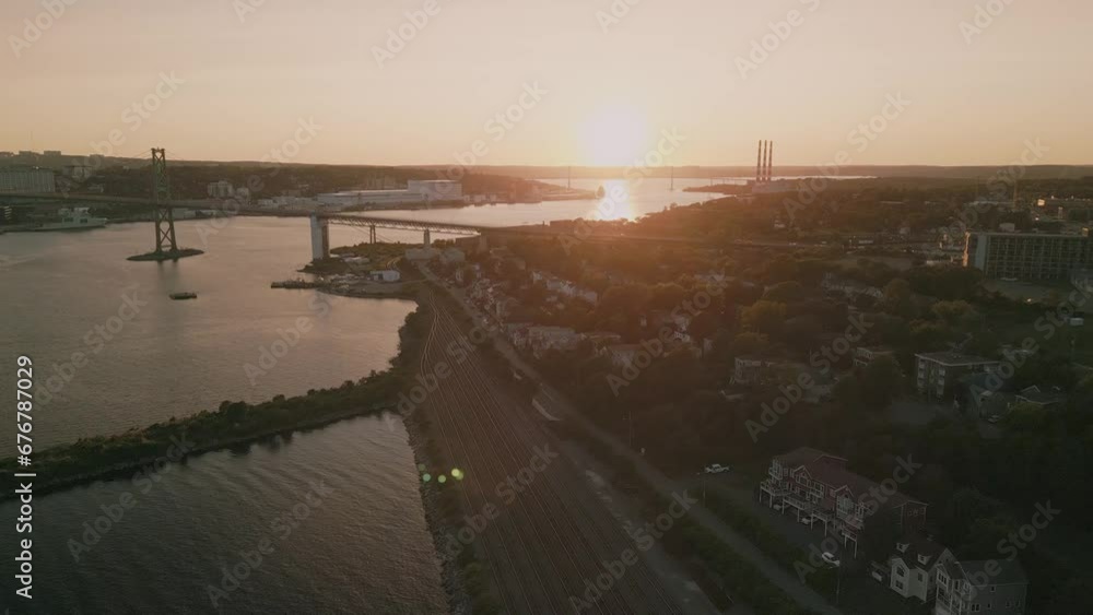 Aerial view of the bay in Halifax with a bridge and a cargo ship at sunset. Aerial view of the bay in Halifax with a bridge and a cargo ship at sunset.