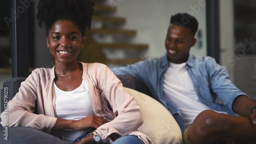 Woman, face or happy in marriage on couch, husband loyalty or security in smile in living room. Black couple, young or portrait by partner commitment, man in support or relax wellness in modern home photo