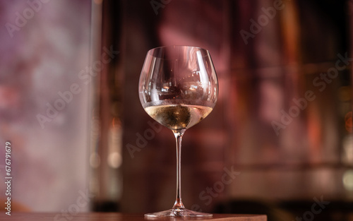 White wine in the wineglass on the table in restaurant