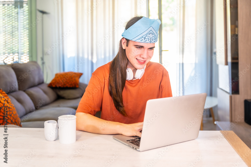 Transgender person working at home using laptop Transgender person working at home using laptop