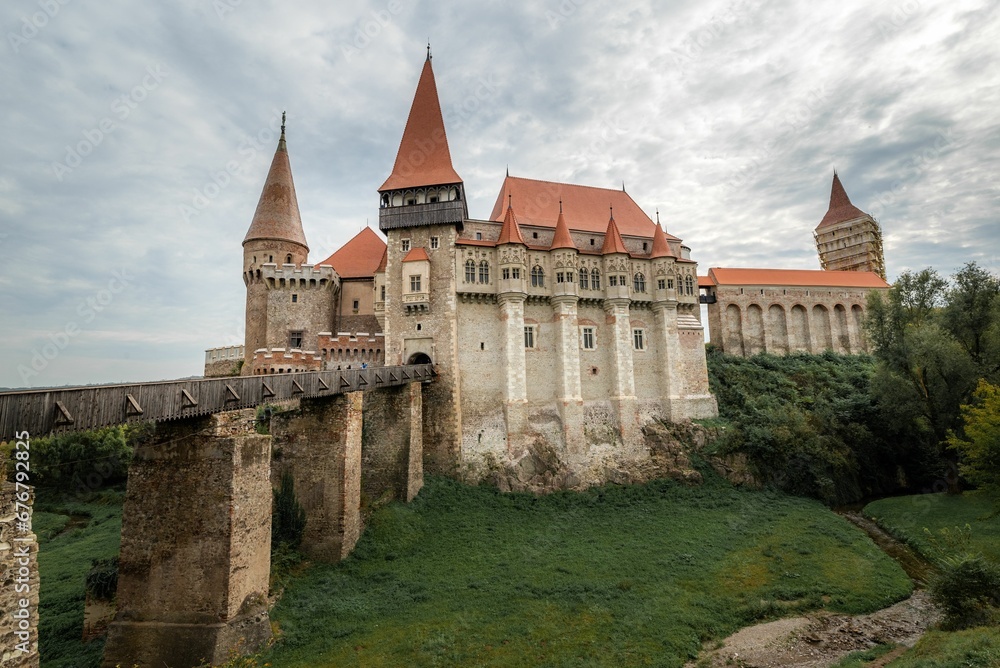 a large castle in a green area with some grass on the ground: Corvin Castle Hunedoara Romania