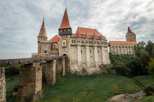 a large castle in a green area with some grass on the ground: Corvin Castle Hunedoara Romania