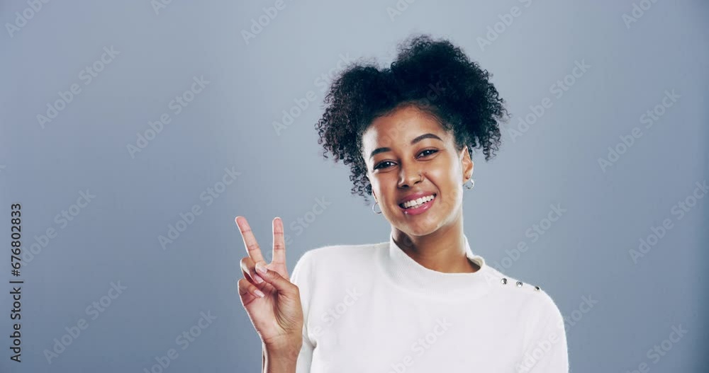Woman, peace hands and happy in studio for motivation, v sign or gesture and freedom on gray background. Person, portrait and emoji with smile, confidence and good mood with mock up space and icon Woman, peace hands and happy in studio for motivation, v sign or gesture and freedom on gray background. Person, portrait and emoji with smile, confidence and good mood with mock up space and icon