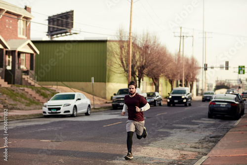 Determined Man Jogging through the City Streets
