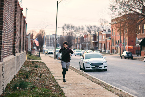 Determined Man Jogging through the City Streets © Geber86