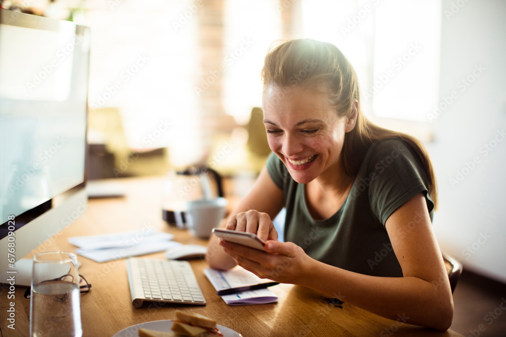 Close up of a happy young woman using her smartphone at home Close up of a happy young woman using her smartphone at home