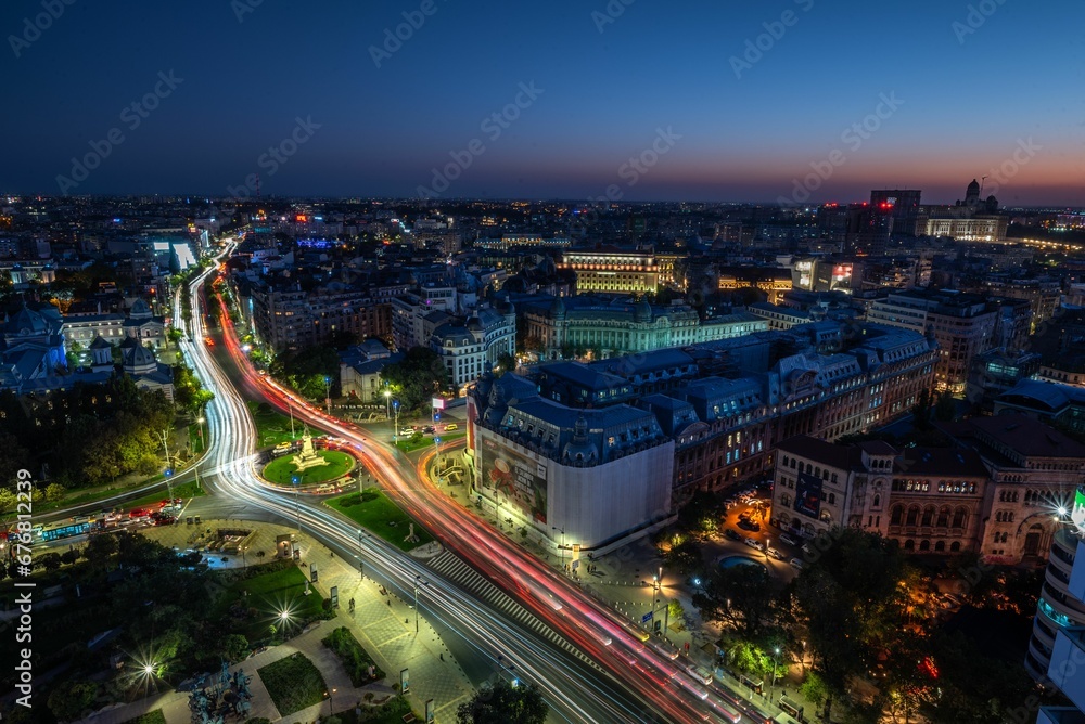 an aerial view of the night city of berlin with a bright street lights and cars