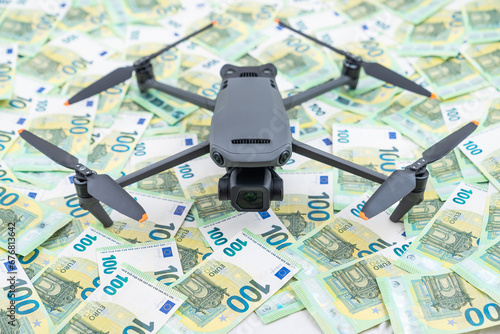 Aerial Drone Flying Remote Control Air Drone over euro bills as background, technology efficiency concept