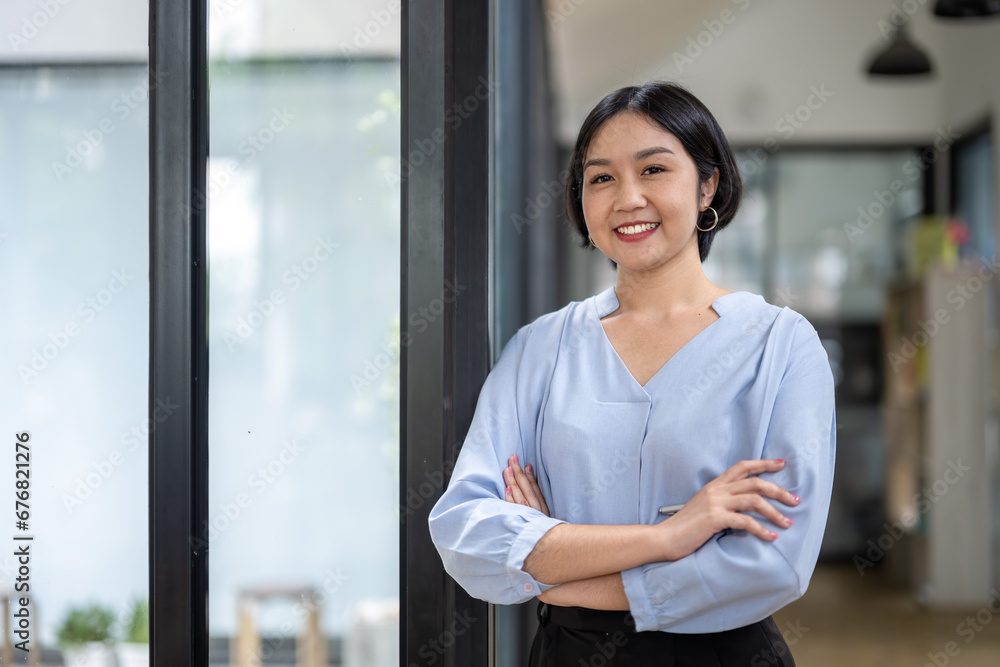 Portrait of confident Asian businesswoman professional standing with arms crossed at workplace. Portrait of confident Asian businesswoman professional standing with arms crossed at workplace.