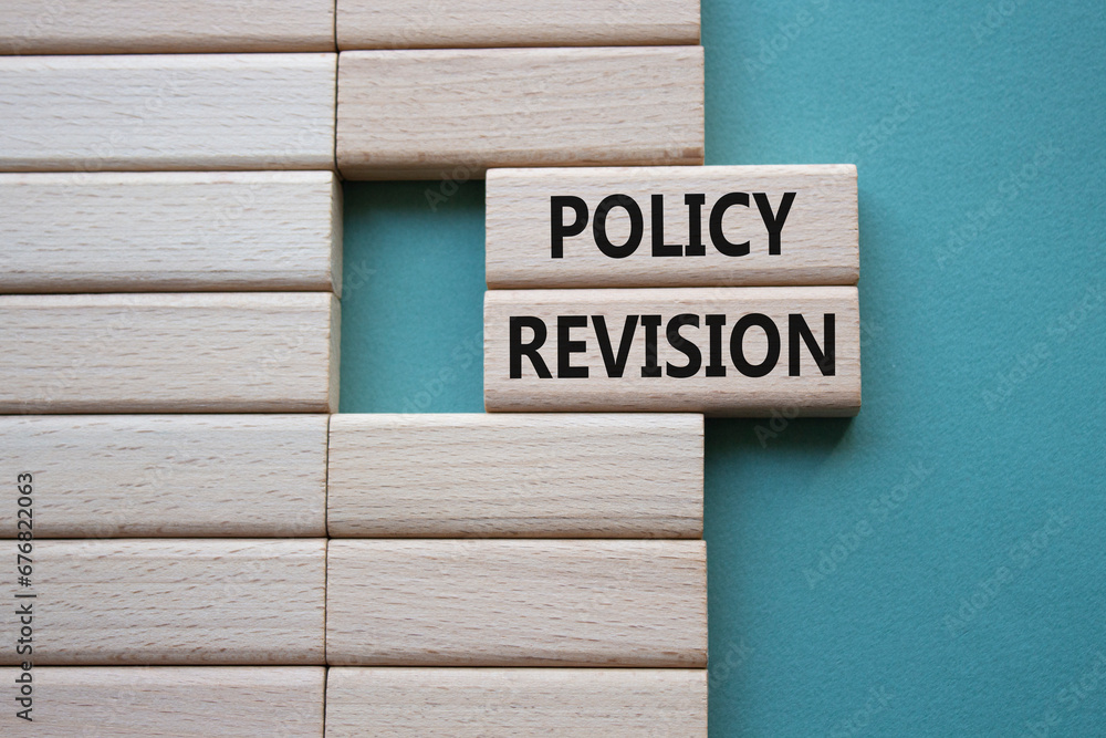 Policy revision symbol. Concept word Policy revision on wooden blocks. Beautiful grey green background. Business and Policy revision concept. Copy space Policy revision symbol. Concept word Policy revision on wooden blocks. Beautiful grey green background. Business and Policy revision concept. Copy space