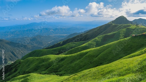Mesmerizing Wugong mountain peaks covered with lush grass under the blue sky in China