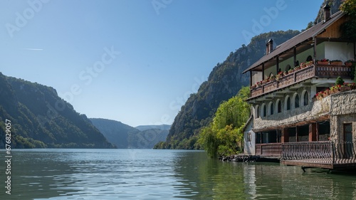 a boat floating down a river near some mountains and cliffs