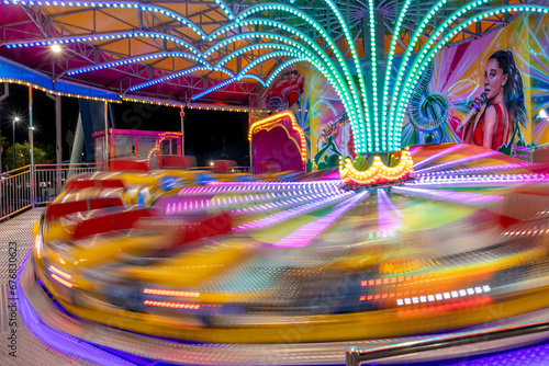 The Tilt-A-Whirl ride gives riders a thrill at full speed at Old Town in Kissimmee (Orlando), Florida.
