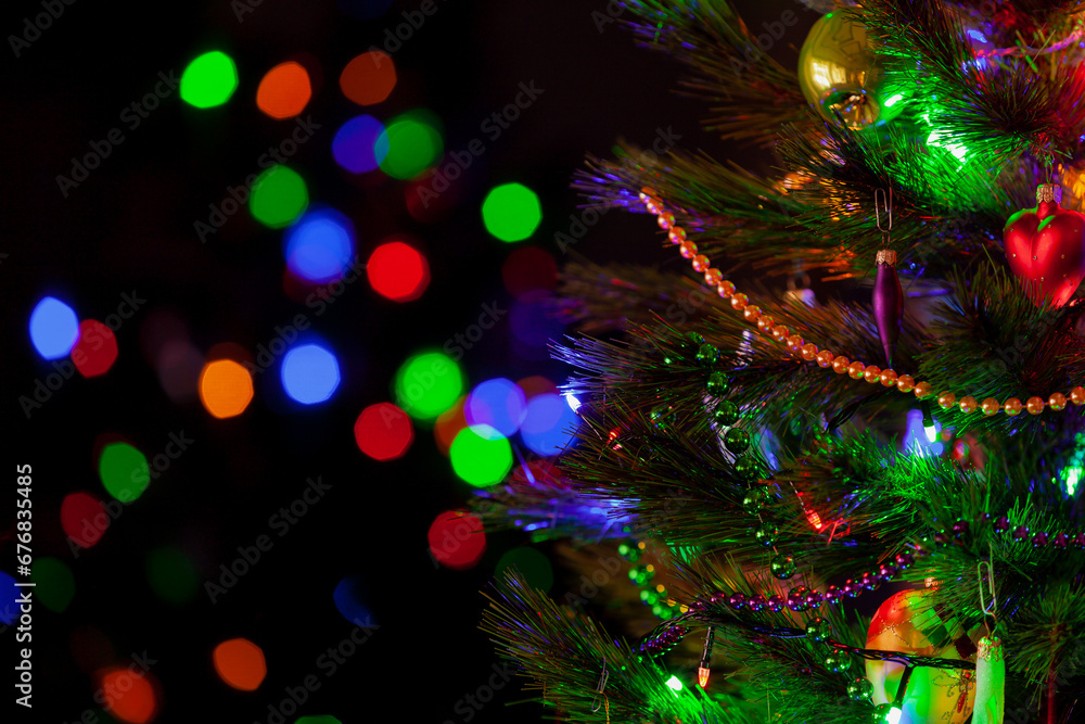 Christmas tree with toys and garlands stands in dark room.... Christmas tree with toys and garlands stands in dark room....