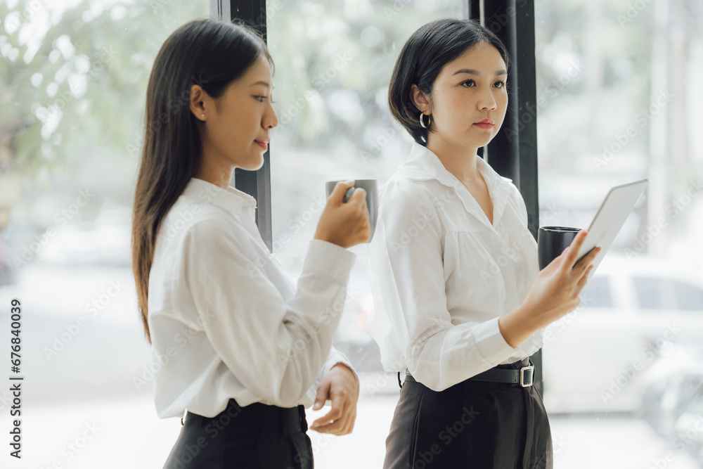 Obraz premium Asian woman in startup company office with happy expression, businesswoman executive and investor in business and stock, management of new generation concept. Start-up company management concepts.