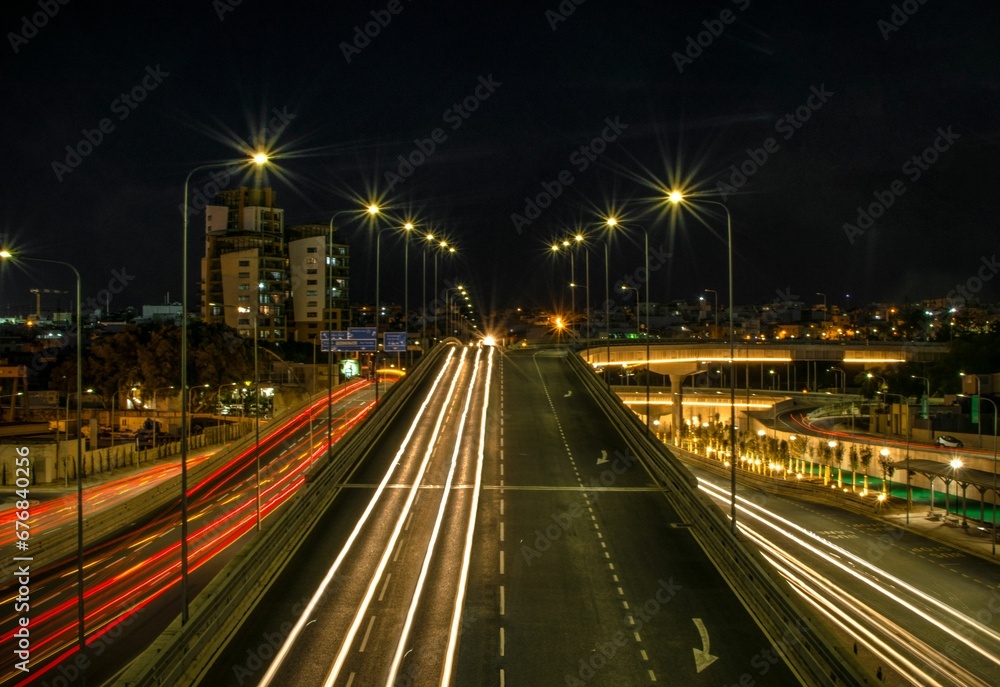 Long exposure shot of the city colorful lights at night and traffic with long exposure highway