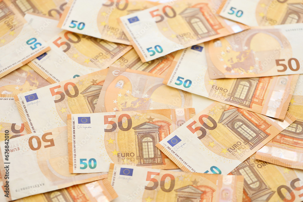 Very big amount of fifty european euro banknotes in huge pile close up Very big amount of fifty european euro banknotes in huge pile close up