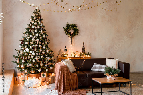Interior of modern living room with comfortable sofa decorated with Christmas tree and gifts