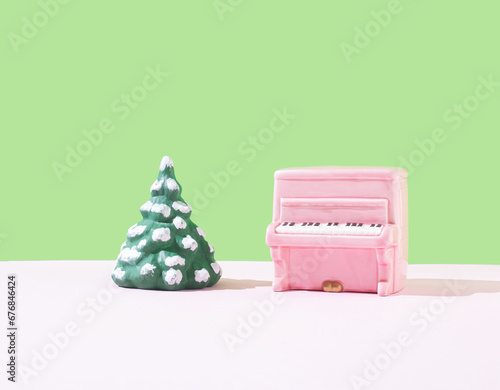 Fototapeta Naklejka Na Ścianę i Meble -  Piano pink color and Christmas tree on the stage. Minimal holiday concept.