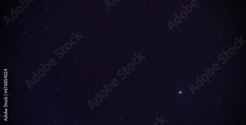 Panorama blue night sky milky way and star on dark background.Universe filled with stars, nebula and galaxy with noise and grain.Photo by long exposure and select white balance.Dark night sky.