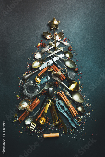 Christmas card. Christmas tree made of kitchen accessories. On a dark background. Top view.