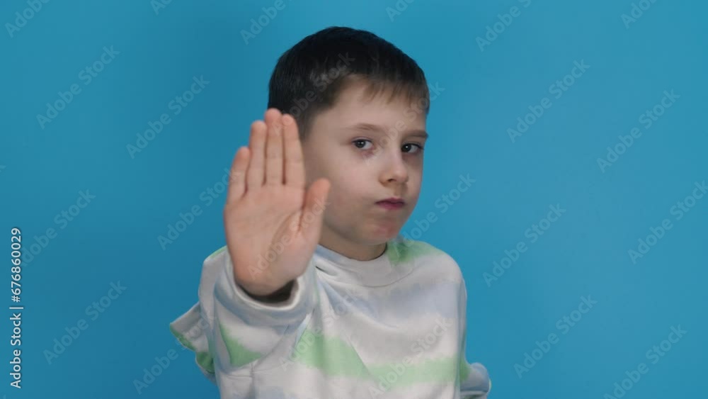 Young man raising hand Gesture. Boy showing sign of rejection. Refusal, denial, stop and negation concepts. Young man raising hand Gesture. Boy showing sign of rejection. Refusal, denial, stop and negation concepts.