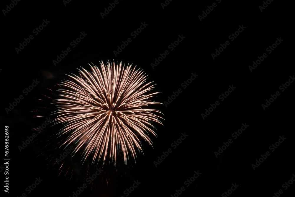 A beautiful festive background with bright yellow fireworks lighting up the black night sky outside A beautiful festive background with bright yellow fireworks lighting up the black night sky outside