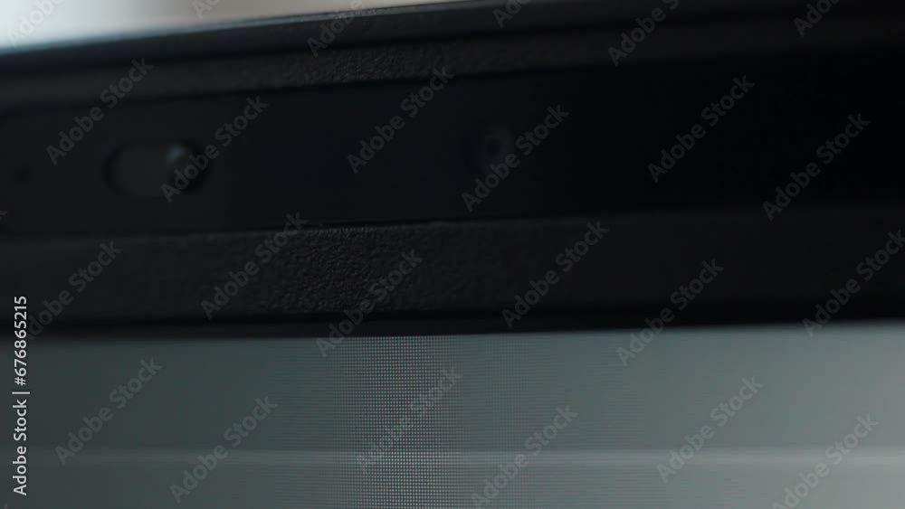 Close up of a laptop camera being open by sliding the shutter lid. Internet Privacy and hacking concept Close up of a laptop camera being open by sliding the shutter lid. Internet Privacy and hacking concept