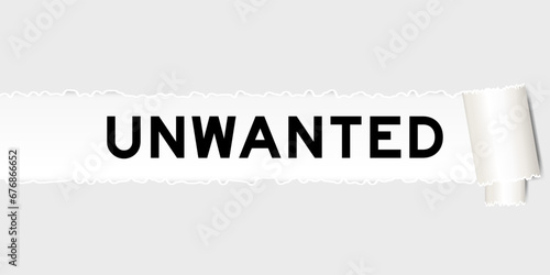 Ripped gray paper background that have word unwanted under torn part