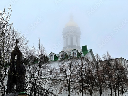 Kiev Pechersk Lavra orthodox monastery bell tower in the fog, Kyiv, Ukraine. photo