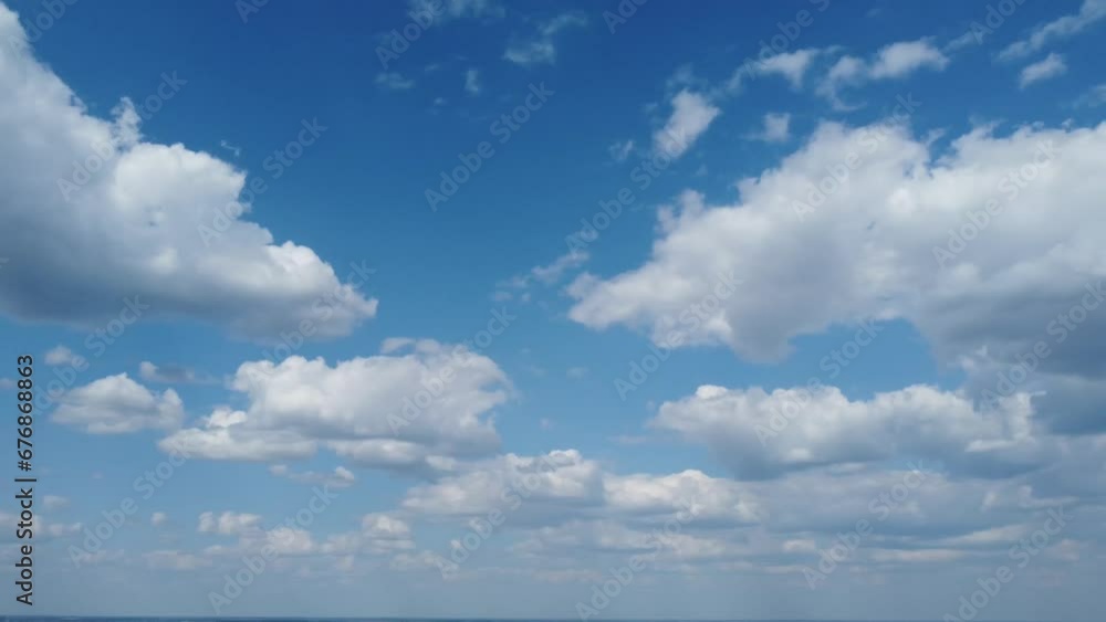 Scenic view of the blue sky with white fluffy clouds Scenic view of the blue sky with white fluffy clouds