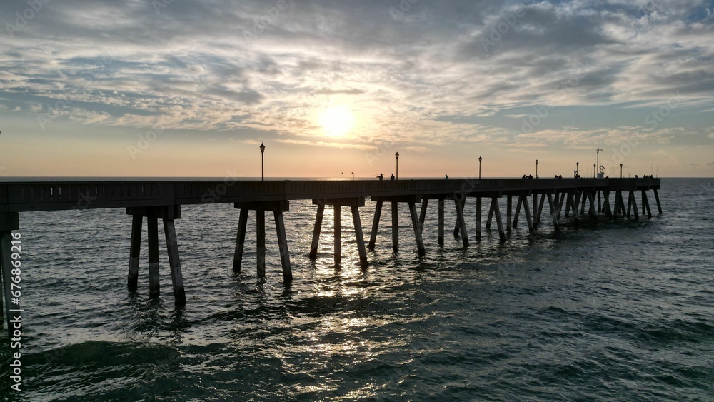 Beautiful sunset over a pier in the sea.