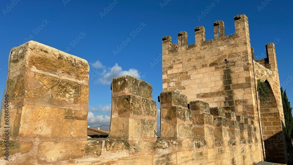 Walls of an ancient fort under a blue sky.