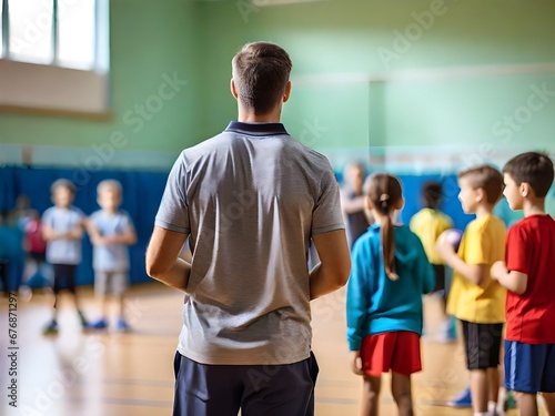 Physical education teacher in sports hall with children
